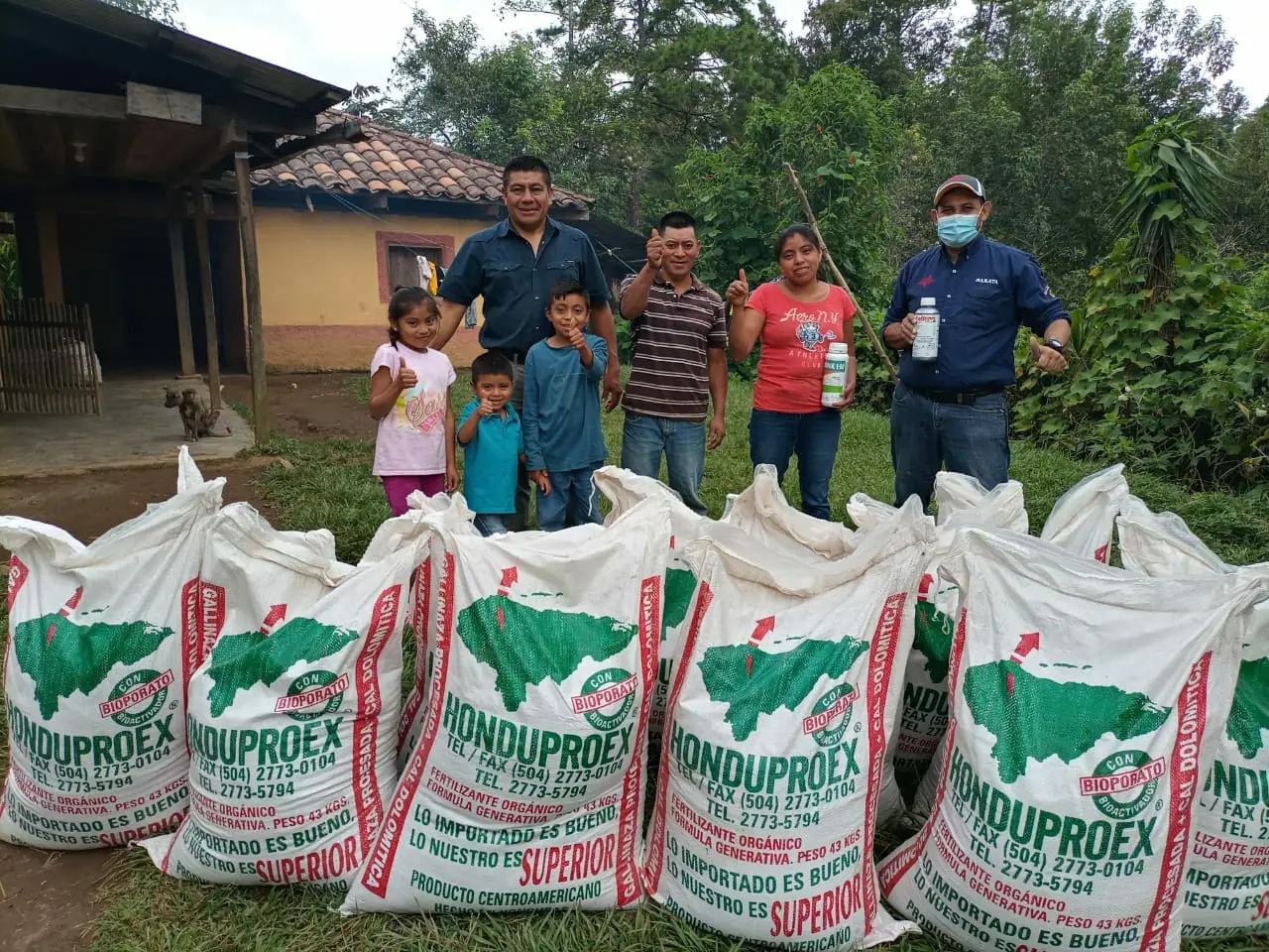 Dilcia and family receiving coffee farming inputs